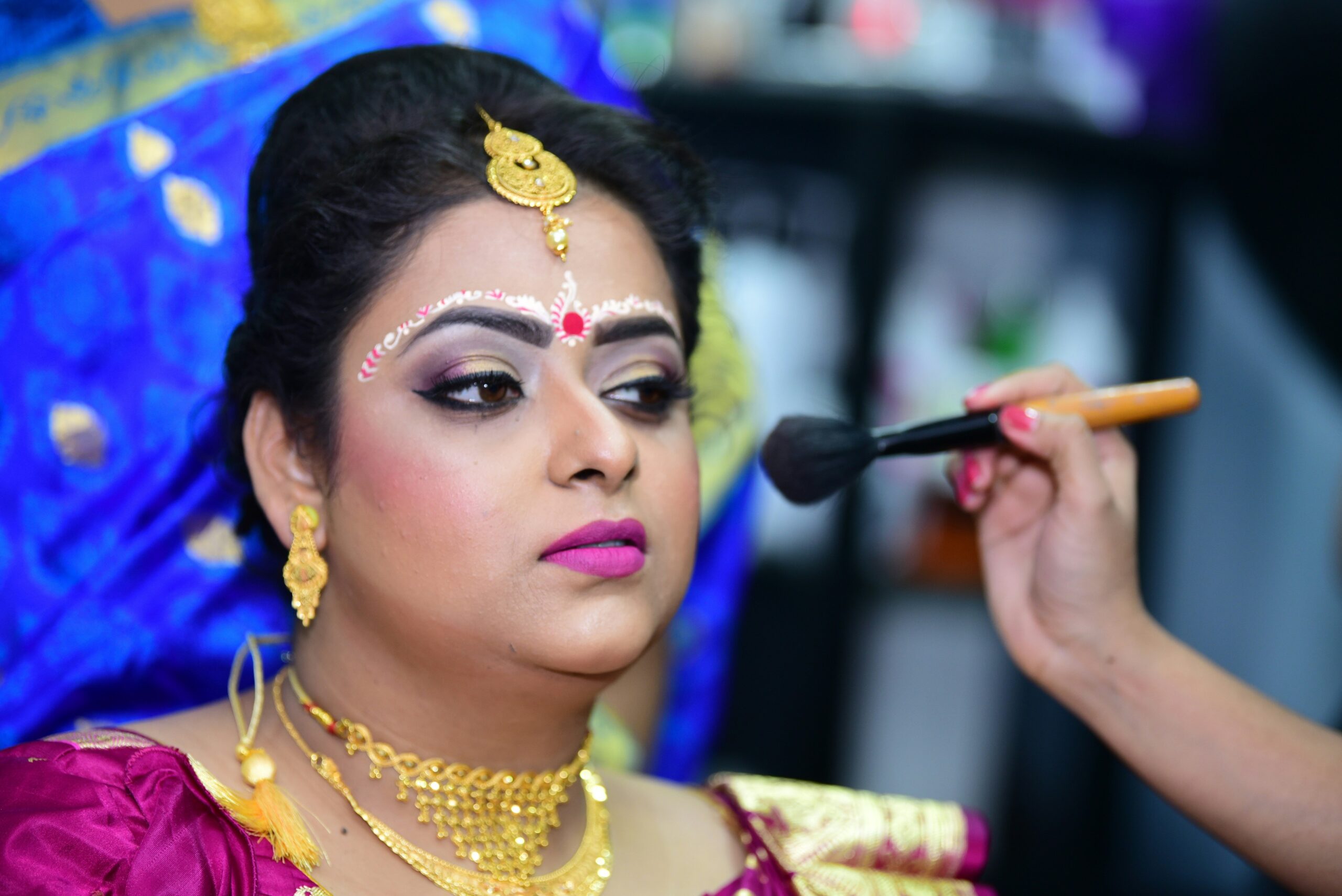 A close-up image showing incorrect vs correct blush application techniques.