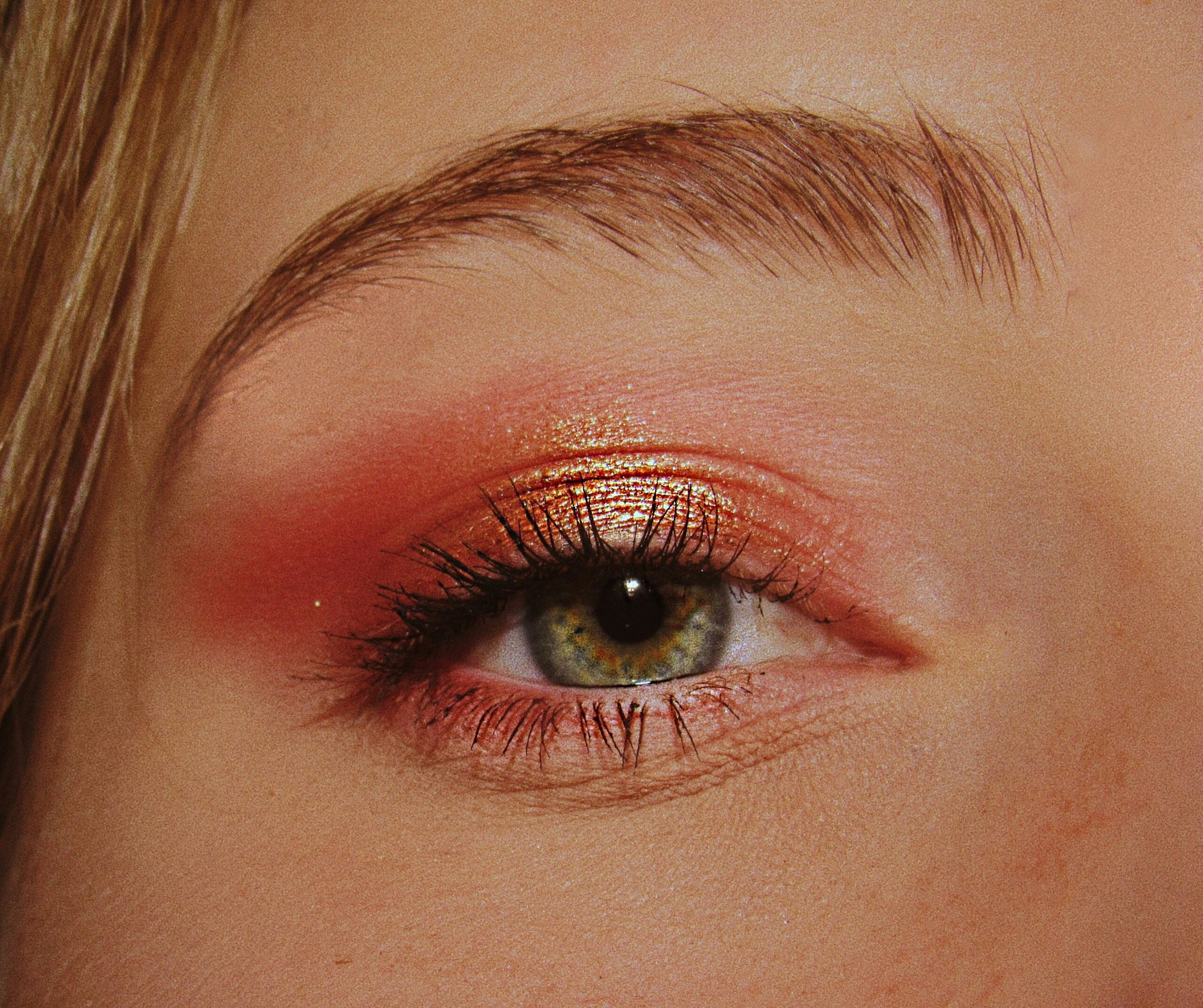 Models wearing bold editorial makeup at a runway show