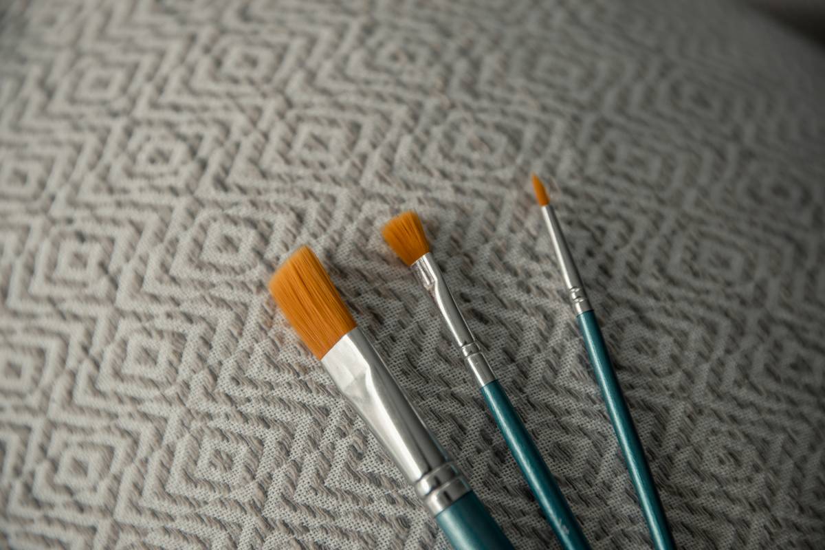 Artist applying multi-dimensional makeup textures to a model’s eyes