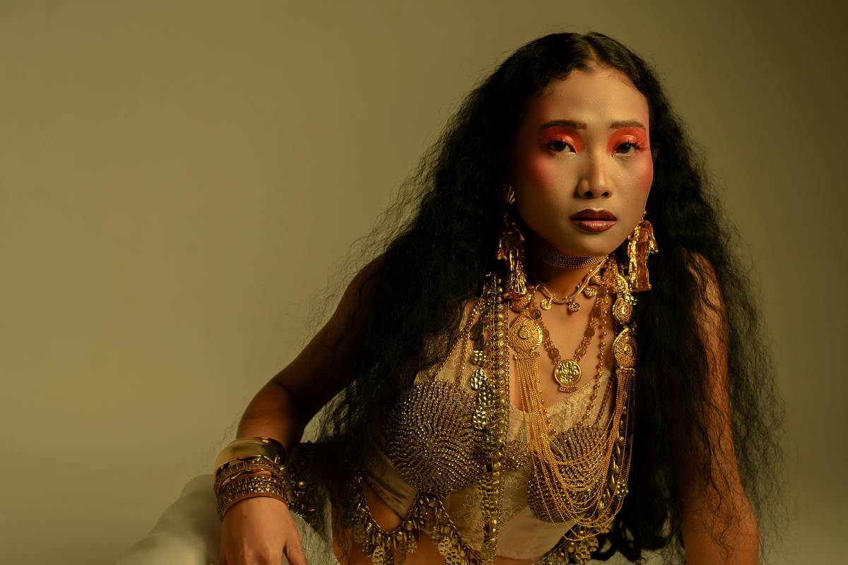 A model showcasing bold runway makeup featuring vibrant colors and geometric designs